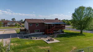 Back of house with a wooden deck, an outdoor fire pit, a patio area, and stairway