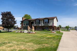 View of front of home featuring brick siding and concrete driveway