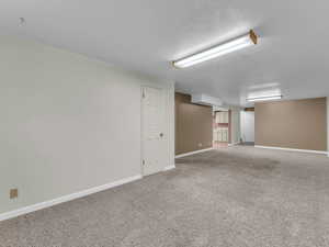 Below grade area featuring baseboards and carpet
