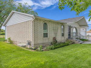 View of property exterior featuring brick siding