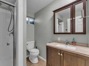 Full bathroom featuring vanity, tile patterned floors, and a stall shower