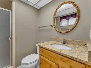 Bathroom with vanity and a stall shower
