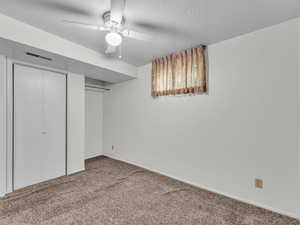 Unfurnished bedroom with carpet flooring and a ceiling fan
