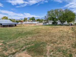 View of yard with a mountain view, an outbuilding, and a pole building