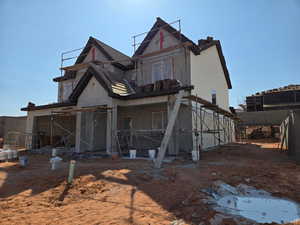 Rear view of property featuring stucco siding