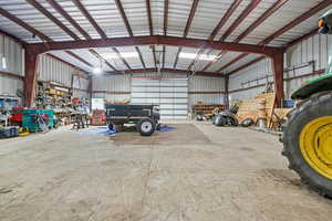 Garage featuring a workshop area and metal wall