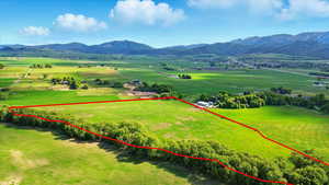 Overview of rural landscape with a mountain backdrop and property boundaries highlighted