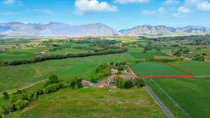 Overview of rural landscape with property boundaries highlighted and a mountain backdrop