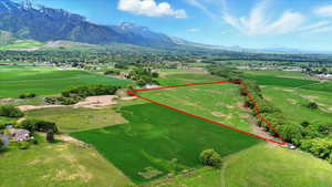 Overview of rural landscape featuring a mountainous background and property parcel outlined