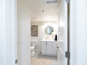 Bathroom featuring vanity and toilet