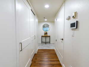 Hall with recessed lighting and wood finished floors