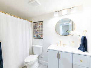 Bathroom featuring vanity and curtained shower