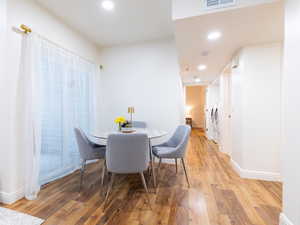Dining room with light wood finished floors, recessed lighting, and washer and clothes dryer