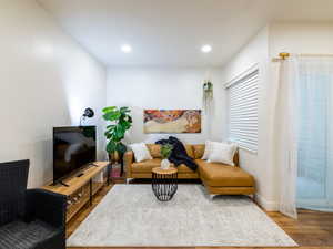 Living area with wood finished floors and recessed lighting