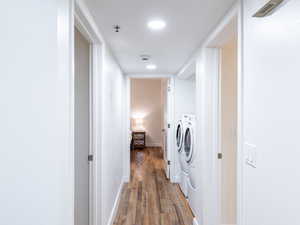 Laundry area featuring washer and clothes dryer and light wood-type flooring