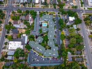 Aerial view of property and surrounding area featuring nearby suburban area
