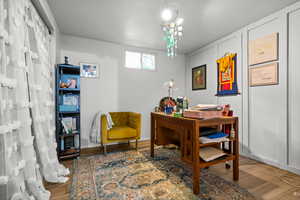 Home office featuring wood finished floors and baseboards