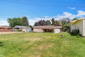 View of yard with a storage unit and a mountain view