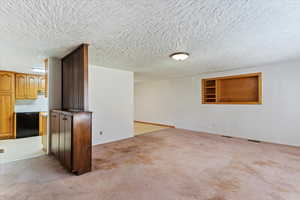 Empty room with light colored carpet