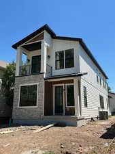 View of front of home with a balcony, a porch.