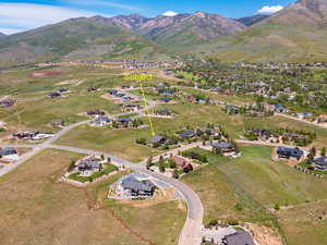 Aerial view of property's location with a mountain backdrop and nearby suburban area