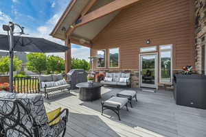 Wooden deck with outdoor lounge area and grilling area