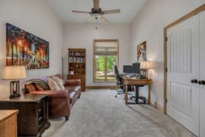 Office space with carpet flooring and ceiling fan