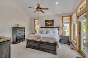 Bedroom featuring lofted ceiling, light carpet, access to exterior, and a ceiling fan