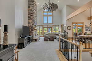 Carpeted living area featuring high vaulted ceiling, healthy amount of natural light, recessed lighting, and beamed ceiling