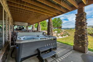 View of patio / terrace featuring a hot tub