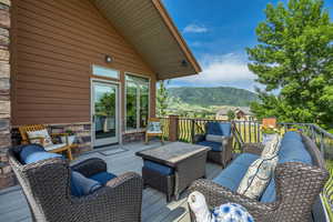Wooden deck featuring a mountain view and an outdoor living space