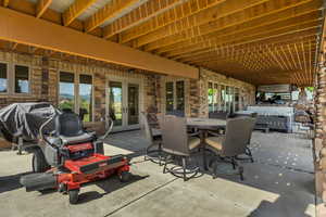 View of patio featuring french doors, grilling area, and outdoor dining area