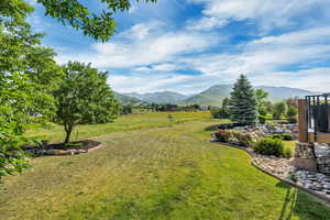 View of grassy yard featuring a mountain view