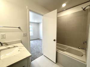 Full bathroom with shower / bath combination and vanity