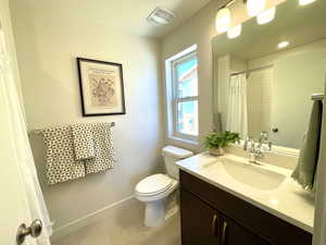 Full bathroom featuring vanity, tile patterned flooring, and a shower with curtain