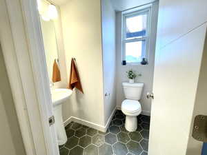 Half bathroom featuring toilet and tile patterned floors