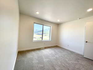 Spare room featuring carpet flooring, recessed lighting, and a smoke detector