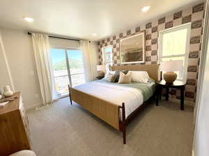 Bedroom featuring wallpapered walls, access to outside, light colored carpet, and recessed lighting