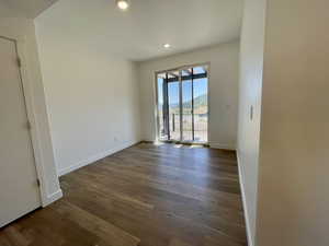 Unfurnished room featuring dark wood-style floors and recessed lighting