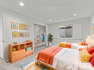 Bedroom featuring light colored carpet, a closet, and recessed lightingPhoto virtually staged