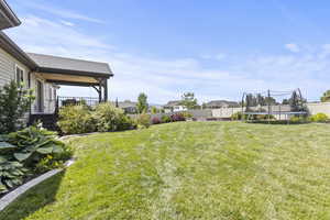 Fenced backyard with a trampoline and a residential view