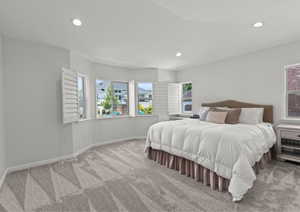 Primary  bedroom featuring multiple windows and recessed lighting