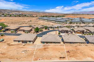 Aerial view of residential area featuring a mountainous background and a desert landscape