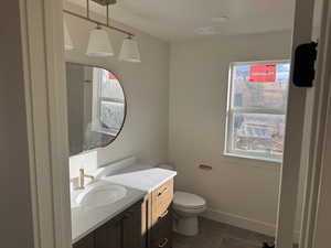 Bathroom with dark tile patterned floors and vanity