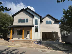 Lot 9 - View of front of house featuring board and batten siding, a porch, a garage, and driveway
