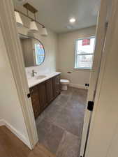 Full bathroom featuring vanity and recessed lighting