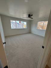Spare room with light carpet and a textured ceiling