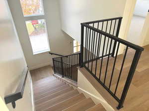 Stairs featuring wood finished floors and baseboards