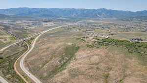 Aerial overview of property's location with a mountain backdrop and rural landscape