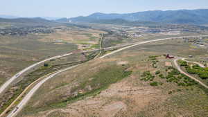 Aerial view of property and surrounding area with mountains and rural landscape